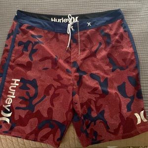 Men’s swimwear, Hurley board shorts, red/blue urban camo pattern.